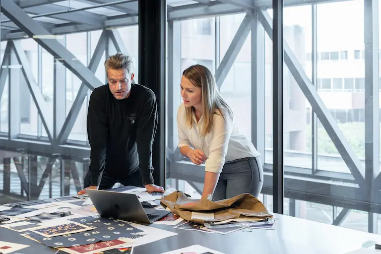 IntegBizz SEO team reviewing growth charts and client results on a screen